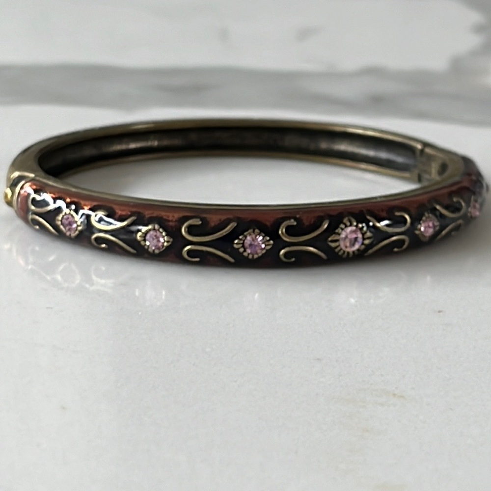 Dark metallic bracelet with purple stones.